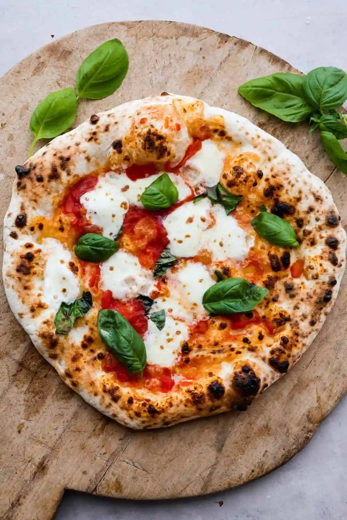 Authentic wood-fired Margherita pizza topped with fresh mozzarella and basil leaves restaurant near me